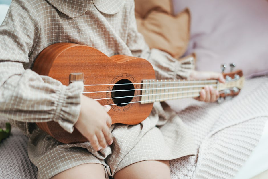 Illustrative image of a person playing an acoustic guitar