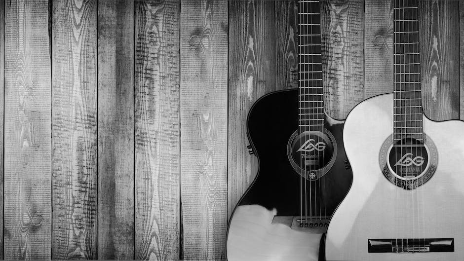 An image of a vintage guitar being played by a musician.