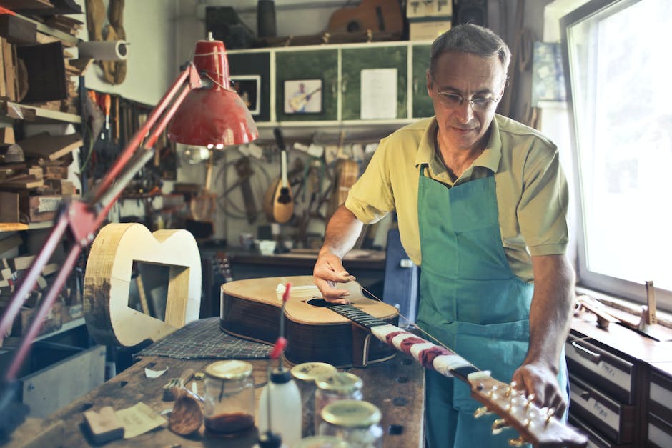 A vintage guitar being maintained with cleaning tools and protective storage.